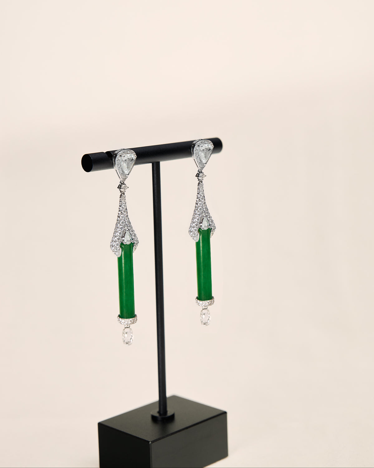 Side profile showcasing The Cylinder Drop Earrings' structural depth and the cylinder passing through the fan base without prongs.