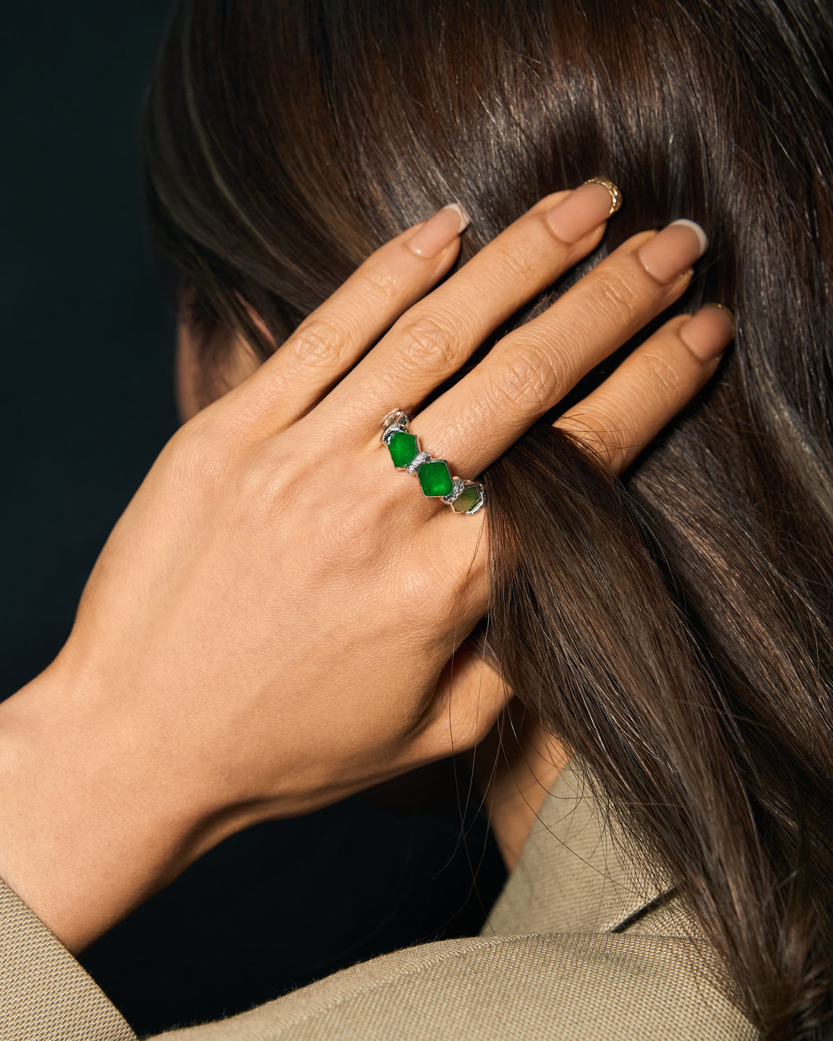The Eternity Ring worn on a hand in motion, showcasing the grounded silhouette and the subtle, shifting kite-like edges of the hexagonal stones.