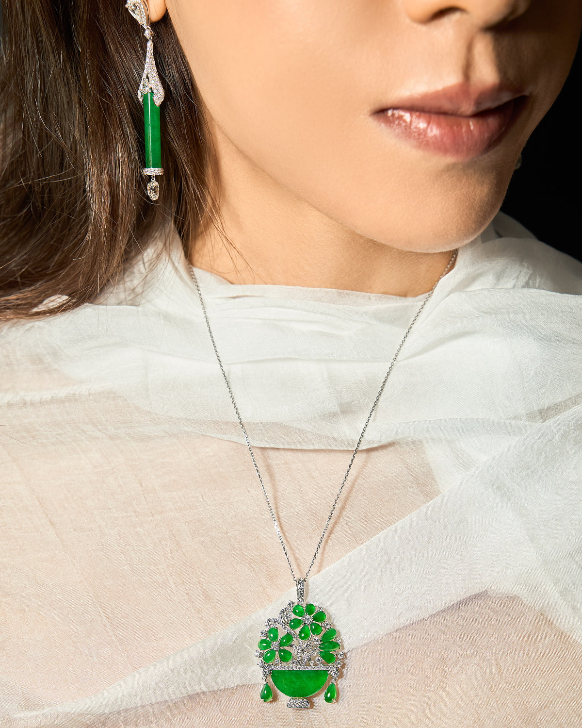 The Floral Pendant worn on a model, showcasing the graceful drape and vivid, lifelike presence of the floral motif at the center of the chest.