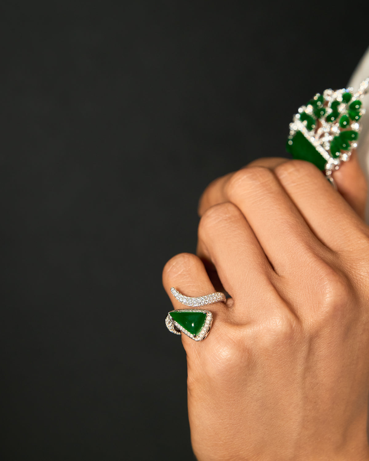 The Orbit Ring worn on a hand, showcasing the reversible triangular silhouette in diagonal orientation and the continuous shimmer of the pavé band.