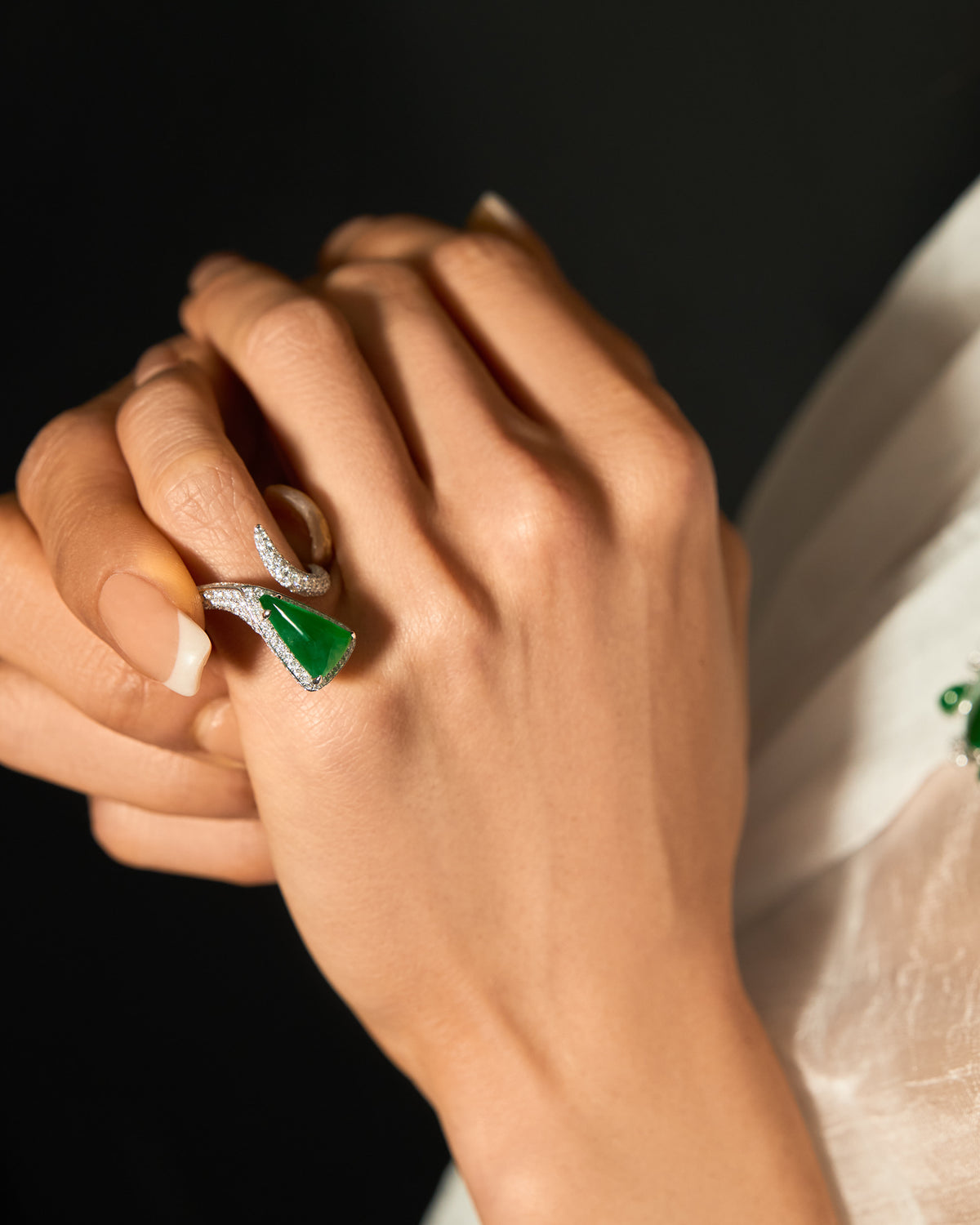 The Orbit Ring worn on a hand, showcasing the reversible triangular silhouette in vertical orientation and the continuous shimmer of the pavé band.