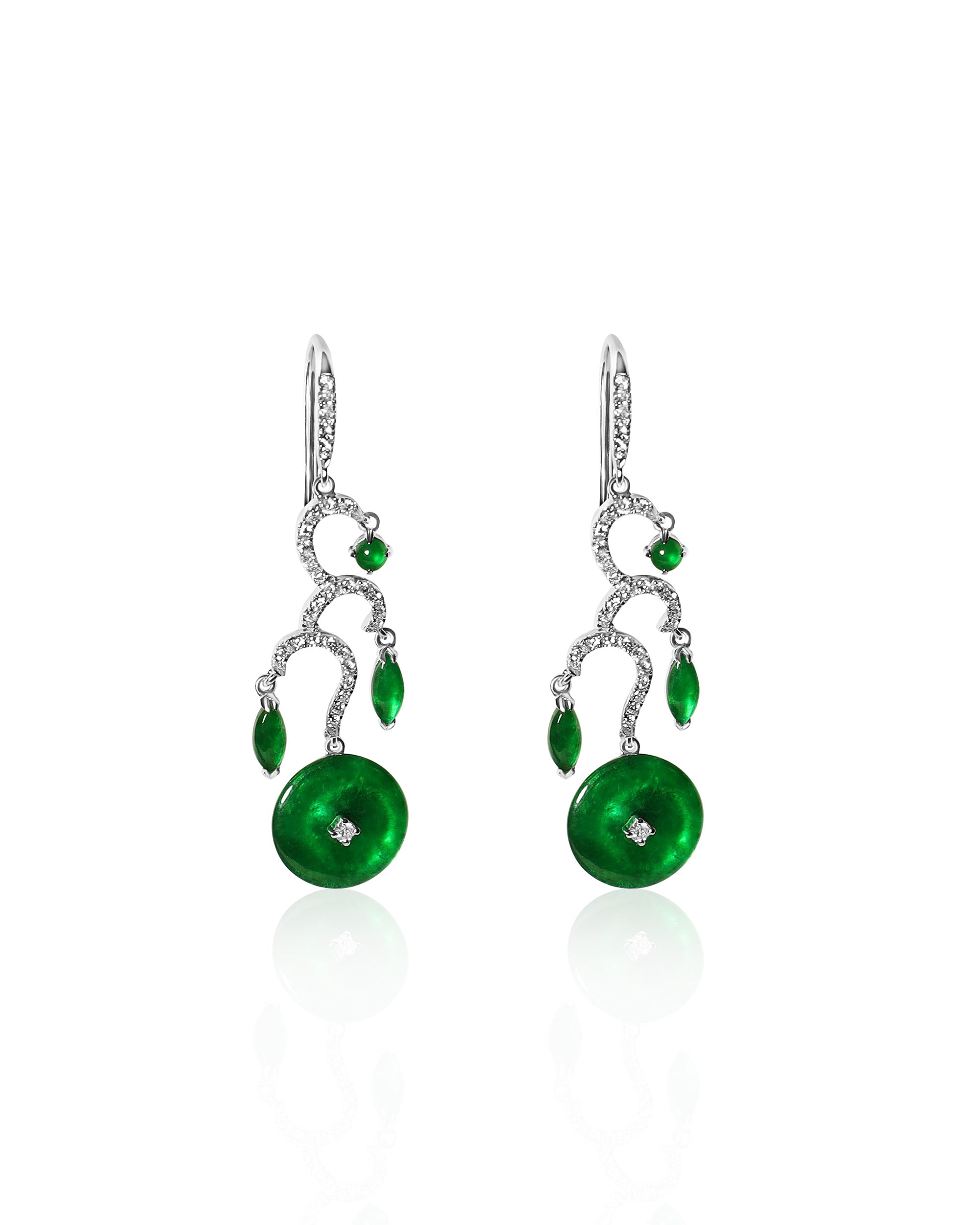 Front view of The Tiered Arc Drop Earrings showing three descending pavé arcs with a round jadeite at the top, marquise-shaped jadeite in the middle, and a huaigu disc at the base, set against a white background.