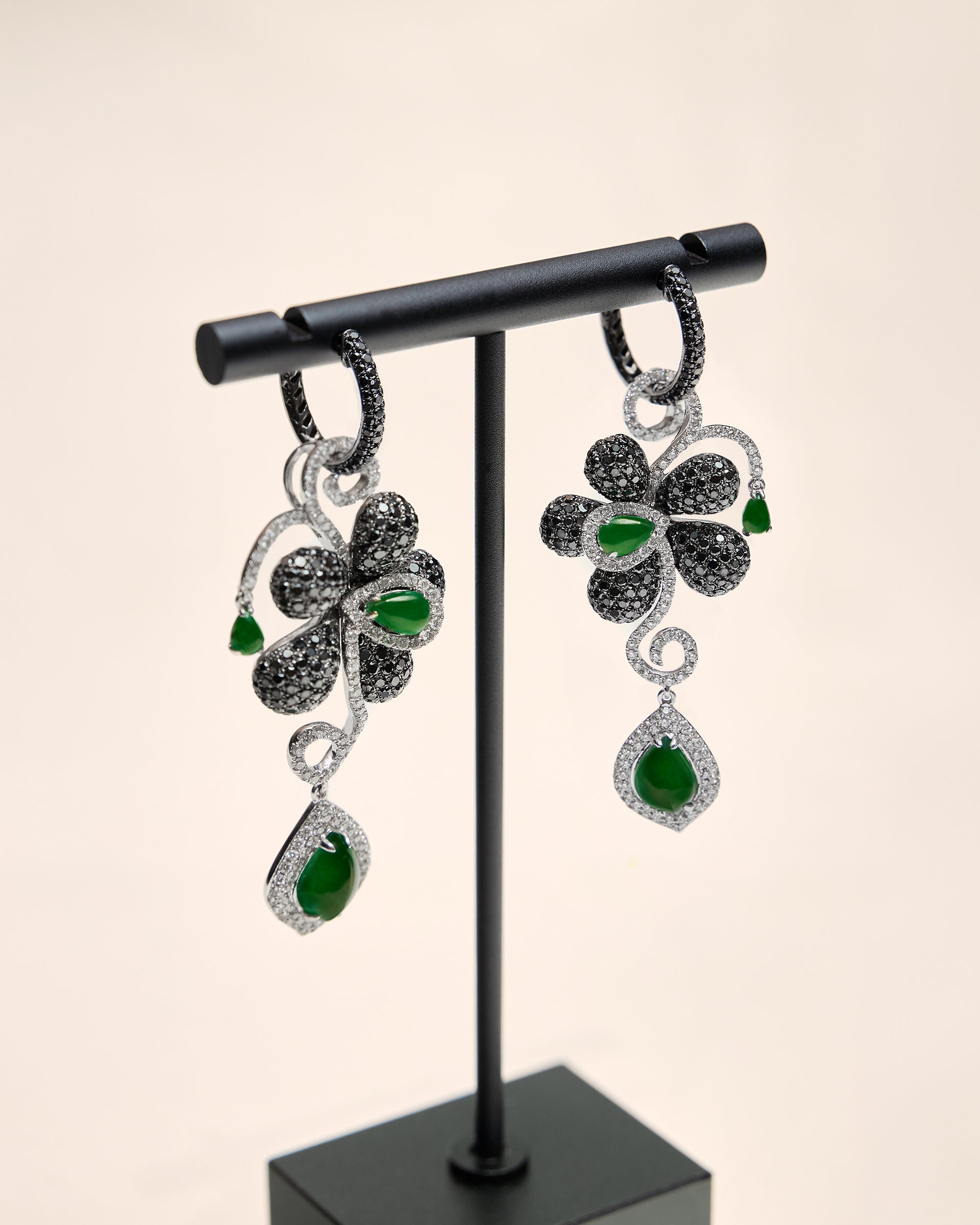 Lateral side profile of The Black Diamond Floral Earrings revealing the structural depth, the three graduated pear-shaped jadeite cabochons in profile, and the concealed metal framework supporting the 65 mm drop.