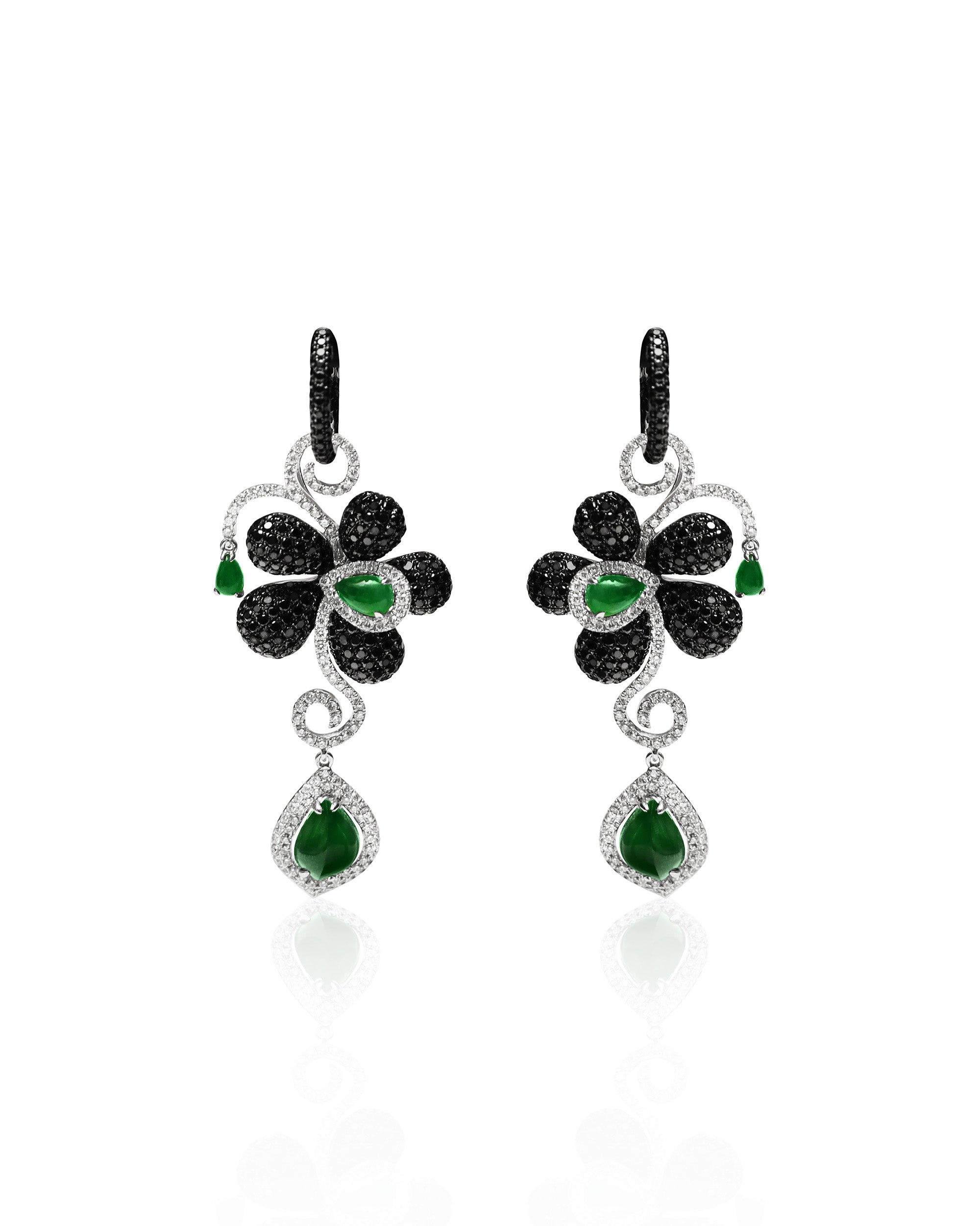 Intense green jadeite drop earrings with black and white diamond pavé floral motif on a white background, front view showing vertical cascade.