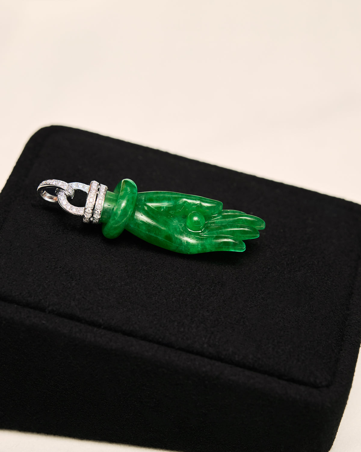Lateral side profile of The Buddha's Palm Pendant on a black background, highlighting the three-dimensional depth and substantial thickness of the carved jadeite.