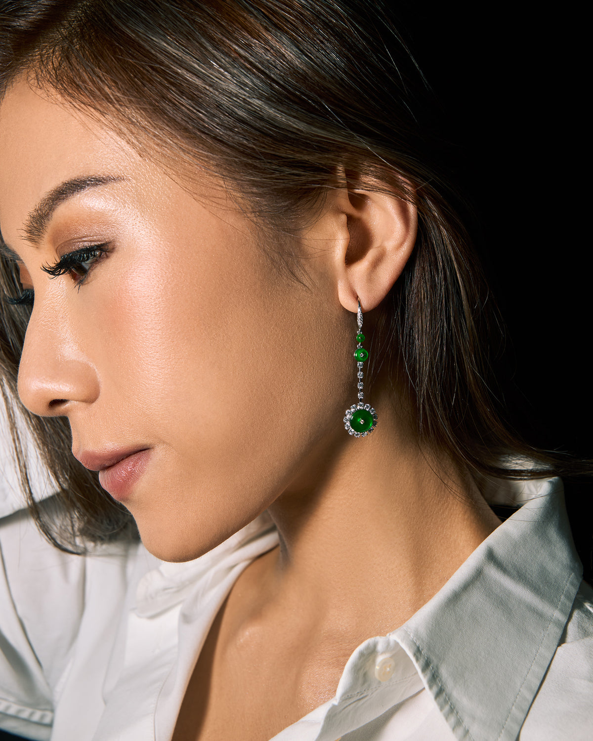 The Disc Drop Earrings worn on a model, highlighting the 50 mm drop length and graceful movement along the jawline.