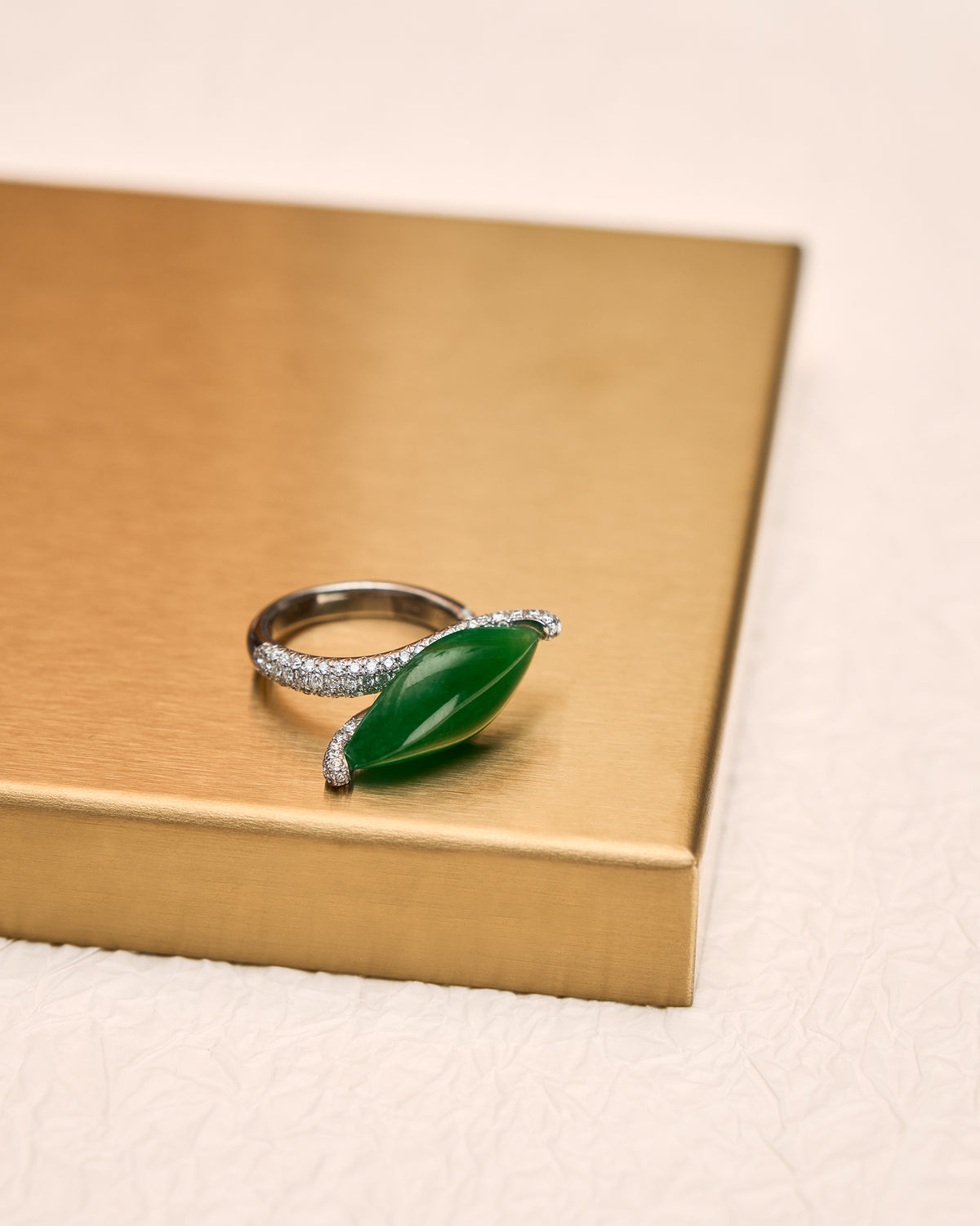 Lateral profile of The East-West Marquise Ring on gold tray highlighting the 7.9 mm setting height and the elegant curve of the bypass band.
