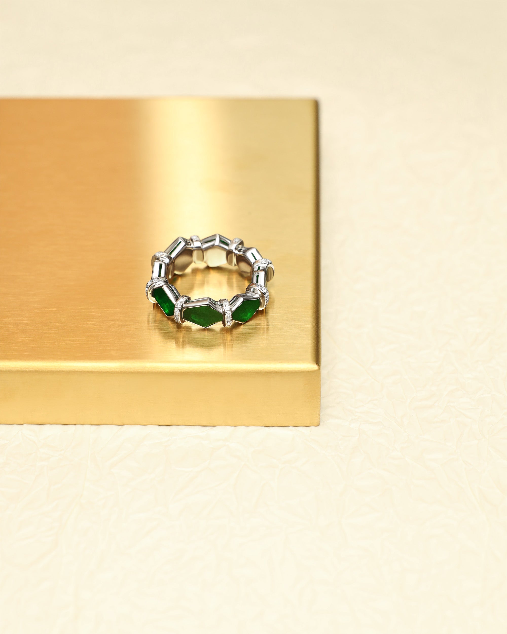 Top-down view of The Eternity Ring showing the hexagonal cabochons with three full faces visible, and the continuous rhythm of the diamond spacers.
